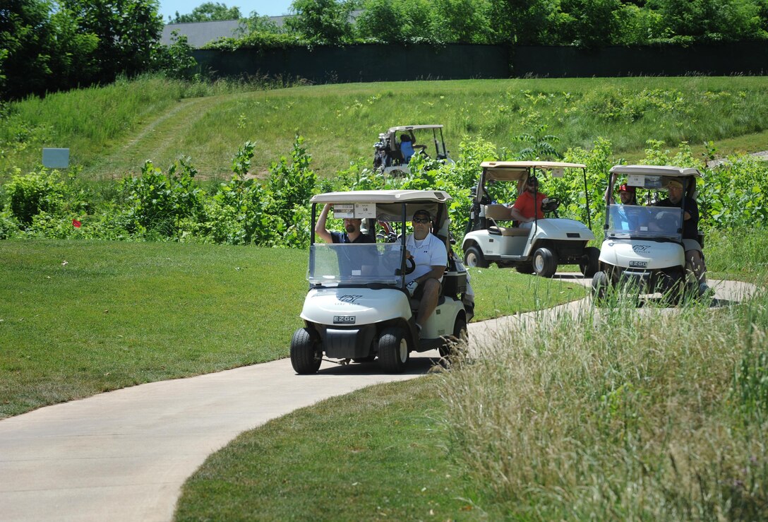 Players make their way to the tee boxes during the 9th Annual ESPN 980 True Heroes Charity Golf Tournament to benefit the Purple Heart Foundation at the 1757 Golf Club in Sterling, Va., June 13, 2016. DoD photo by Marvin D. Lynchard 
