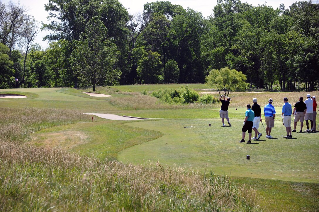 A group of golfers tee off on a par 3 hole during the 9th Annual ESPN 980 True Heroes Charity Golf Tournament to benefit the Purple Heart Foundation at the 1757 Golf Club in Sterling, Va., June 13, 2016. DoD photo by Marvin D. Lynchard 