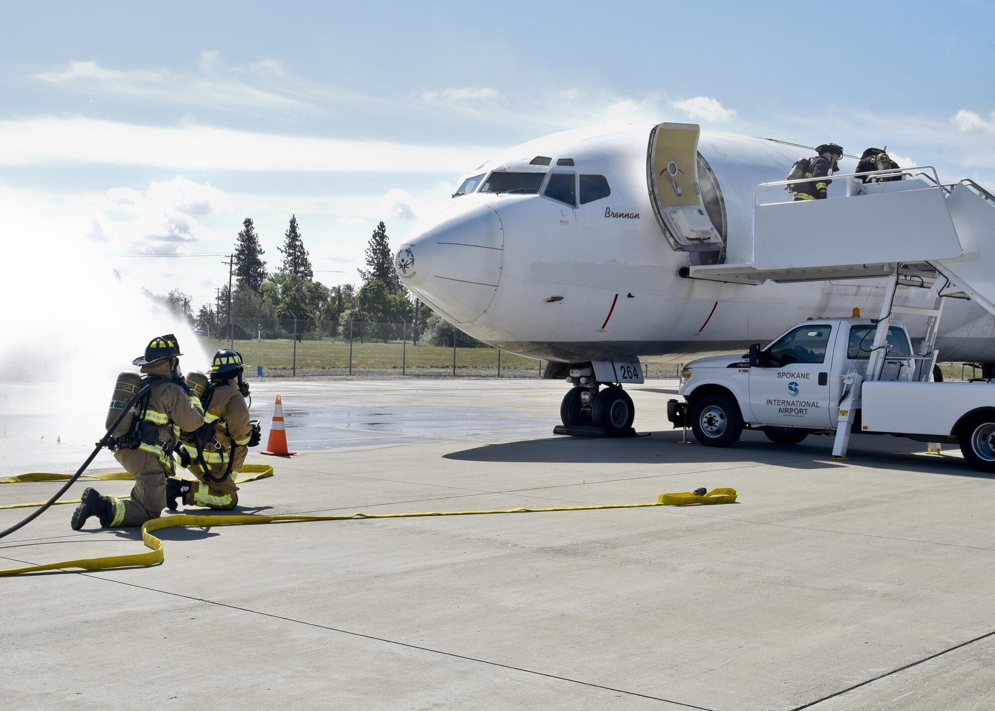 92nd Civil Engineer Squadron firefighters assist Spokane International Airport firefighters during an exercise June 9, 2016, at Spokane International Airport, Wash. The exercise simulated an aircraft crash during an emergency landing with 112 passengers on board. The objective was to provide responders with the opportunity to practice the airport’s Emergency Response Plan. (U.S. Air Force photo/Airman 1st Class Taylor Shelton) 
