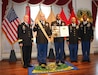 Army Reserve Col. William J. McLaen, the chief of staff for the 310th Sustainment Command (Expeditionary) (center left), and Command Sgt. Maj. Levi G. Maynard, the senior enlisted advisor for the 310th Sustainment Command (Expeditionary) (center right), represented the 310th ESC while receiving the Distinguished Unit of the Regiment award at the United States Army Quartermaster School Regimental Honors Ceremony, an annual event that honors distinguished members and units of the Quartermaster Corps for their achievements and service in the Army Sustainment community at Fort Lee, Va., 10 June, 2016.