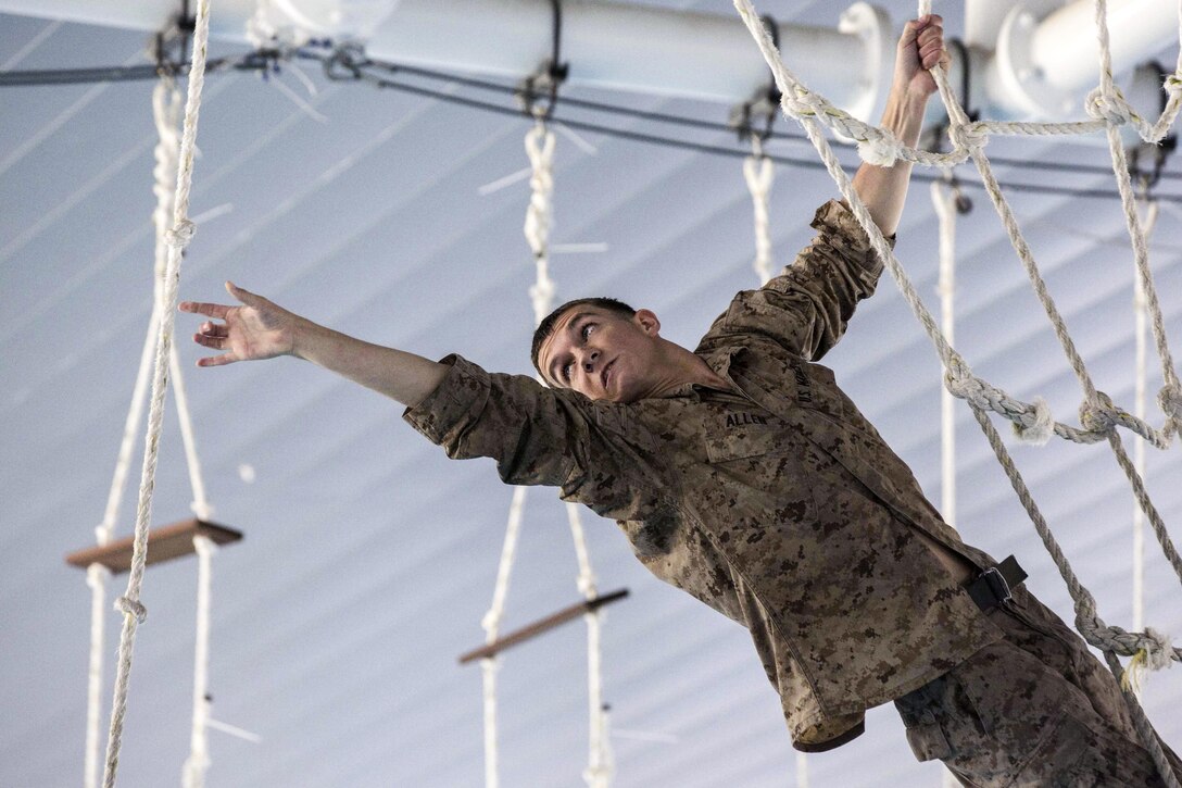 Marine Corps Cpl. Jackson T. Allen reaches for a rope on an over-water obstacle course at Gallipoli Barracks in Brisbane, Australia, June 7, 2016. The course is part of fitness training intended to keep Marines in good physical condition during their six-month deployment to Darwin, Australia. Marine Corps photo by Lance Cpl. Osvaldo Ortega