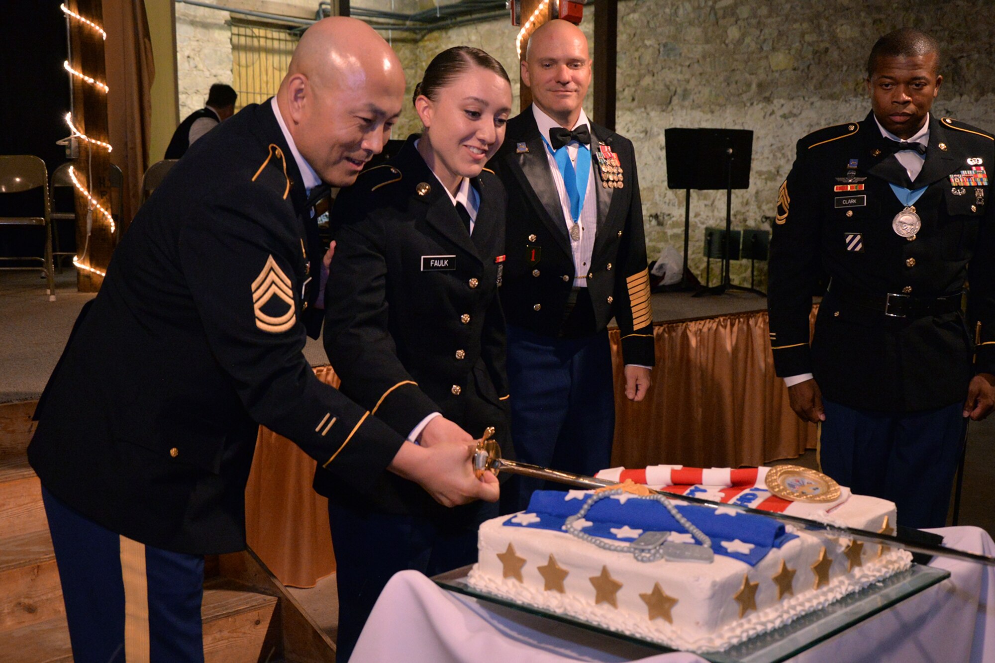 U.S. Army Sgt. 1st Class Scott Choi, 344th Military Intelligence Battalion instructor, and Pvt. Bailey Faulk, 344th MI BN student, cut a cake during the 344th MI BN Army Ball at the Fort Concho Stables in San Angelo, Texas, June 10, 2016. It is a long-held tradition that the birthday cake is cut by the most senior member or veteran and youngest member present. (U.S. Air Force photo by Airman 1st Class Randall Moose/Released)