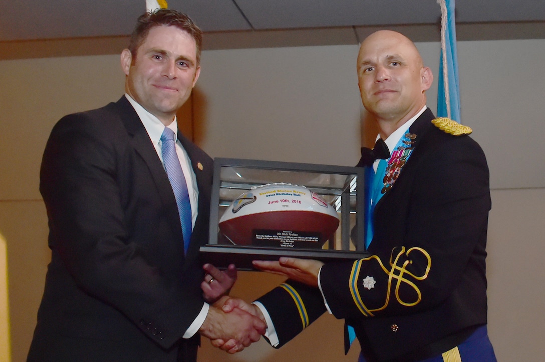 U.S. Army Lt. Col. Andrew Pekala, 743rd Military Intelligence Battalion commander, hands a recognition gift to guest speaker Nicholas Freitas, Virginia House of Delegates member, June 10, 2016, at Sports Authority Field at Mile High in Denver, during the 743rd Military Intelligence Battalion’s Army Ball. The 743rd MIB celebrated the 241st birthday of the U.S. Army. (U.S. Air Force photo by Airman 1st Class Luke W. Nowakowski/Released)