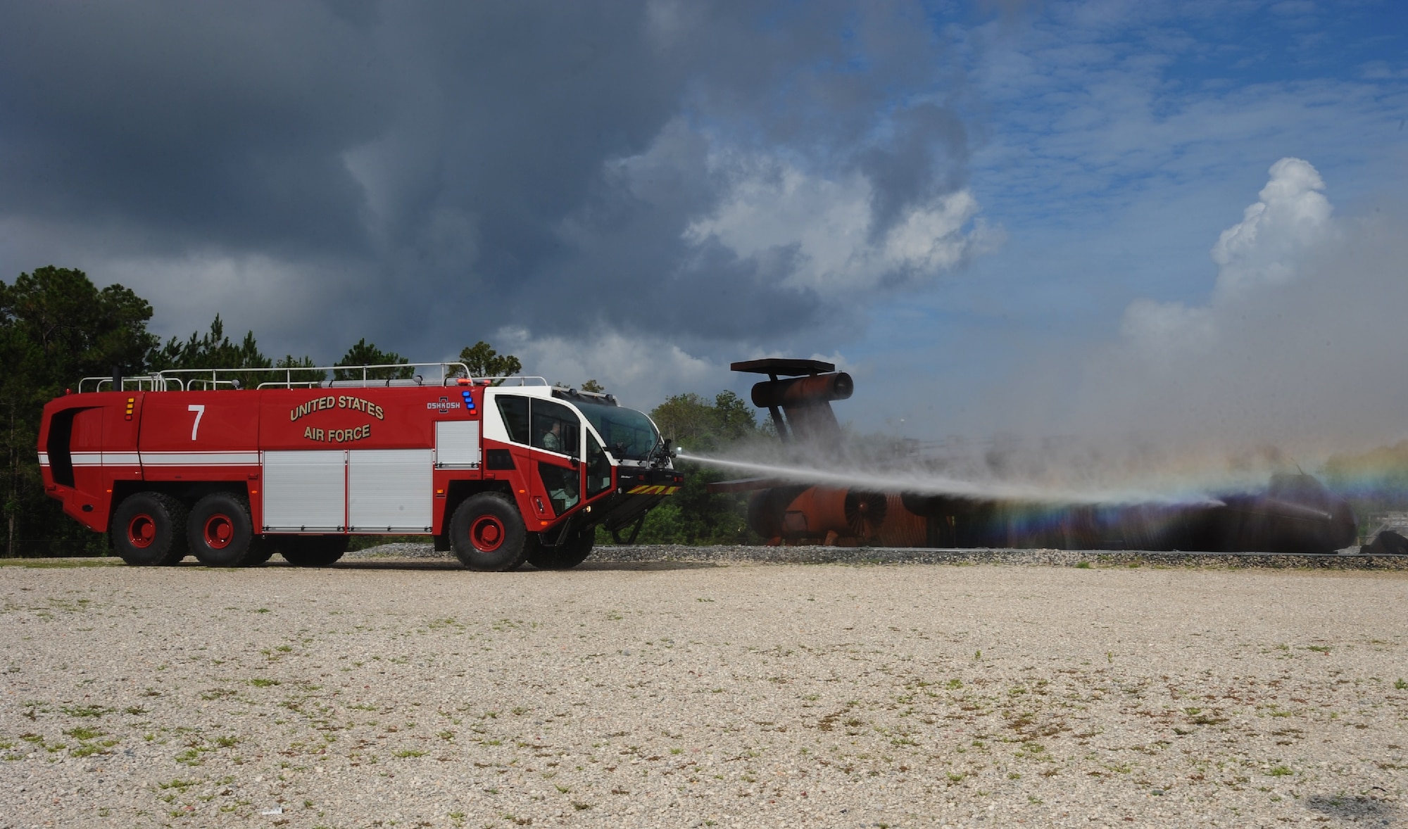 Airmen assigned to the 6th Civil Engineer Squadron use a new Striker 3000 fire truck during a training demonstration June 9, 2016 at MacDill Air Force Base, Fla. The new trucks feature a water pump capable of pushing water out at 1,400 pounds per square inch which creates a finer water particle able to extinguish fire more effectively. (U.S. Air Force photo by Airman Adam R. Shanks)