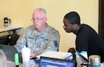 New York Army National Guard Maj. (Dr.) Joel Bachman works with a Soldier during a medical readiness check at Camp Smith Training Site near Peekskill, N.Y. on June 11, 2016. Bachman  has received the Dental Corps Chief's Award of Excellence for 2016 as the top dentist in the Army National Guard and Army Reserve. 