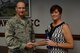 Llawayne Reid, 20th Comptroller Squadron civilian pay technician, receives an Airman Up! award from U.S. Air Force Col. Stephen Jost, 20th Fighter Wing commander, at Shaw Air Force Base, S.C., June 8, 2016. Reid is in charge of pay for the civilians of the 20th FW, taking care of Team Shaw so they can remain focused on the mission. The Airman Up! campaign is intended to challenge Airmen – enlisted, officer, and civilian – to push themselves toward personal development and increased resiliency. As a recipient of the award, Reid was given a water bottle and was recognized at the wing’s bi-weekly meeting. (U.S. Air Force photo by Airman 1st Class Kelsey Tucker)