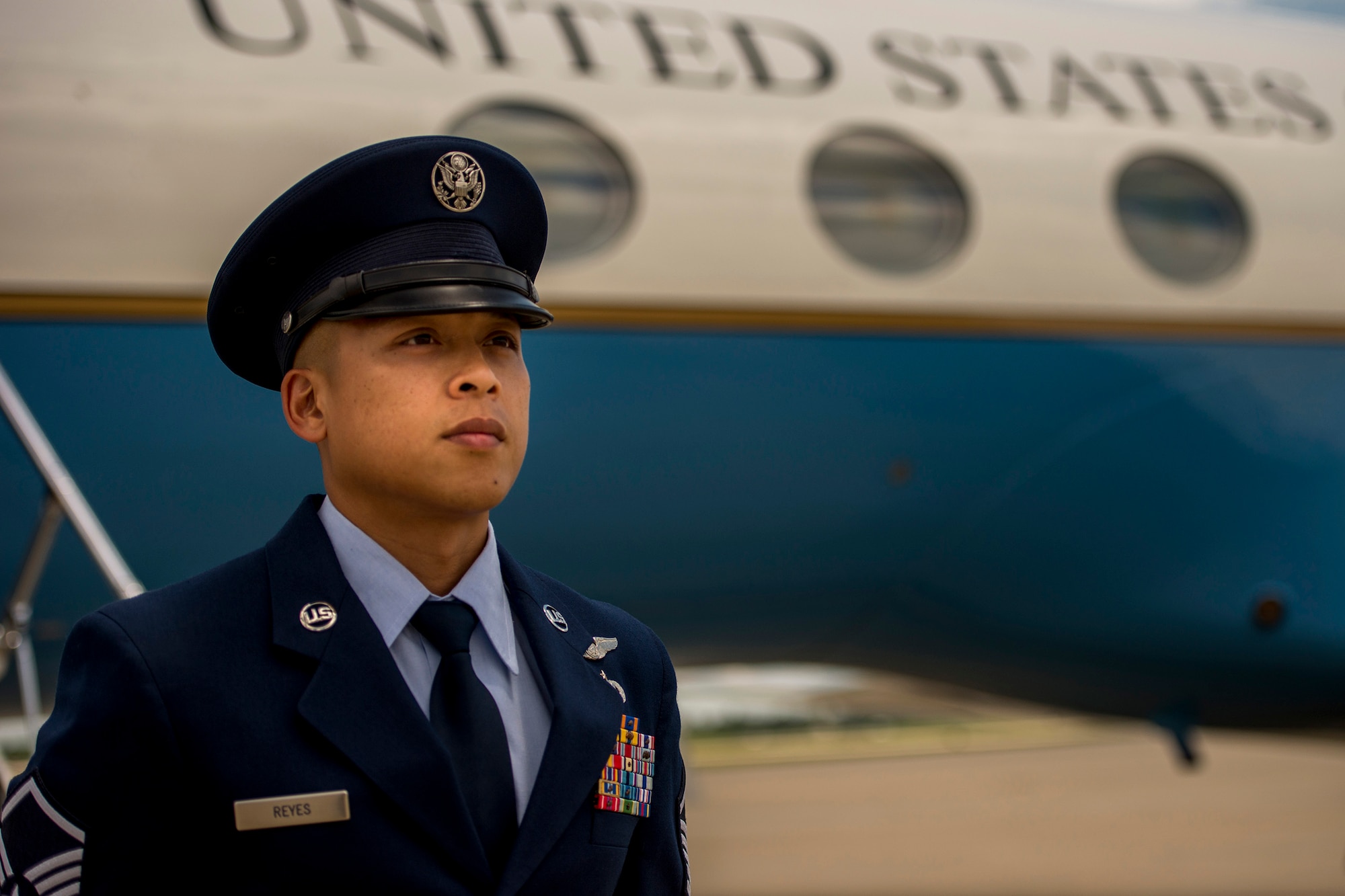 Master Sgt. Kristofer Reyes, a 99th Airlift Squadron flight engineer, stands at parade rest in front of a C-37A and awaits the arrival of a U.S. senior elected leader at Joint Base Andrews, Md., June 7, 2016. In addition to monitoring and maintaining the mechanical and electrical systems on the C-37A, a highly modified Gulfstream G5 aircraft, flight engineers are also responsible for greeting their customers, which are typically the U.S. vice president, cabinet members, combatant commanders, and other senior military and elected leaders. (U.S. Air Force photo/Senior Master Sgt. Kevin Wallace)