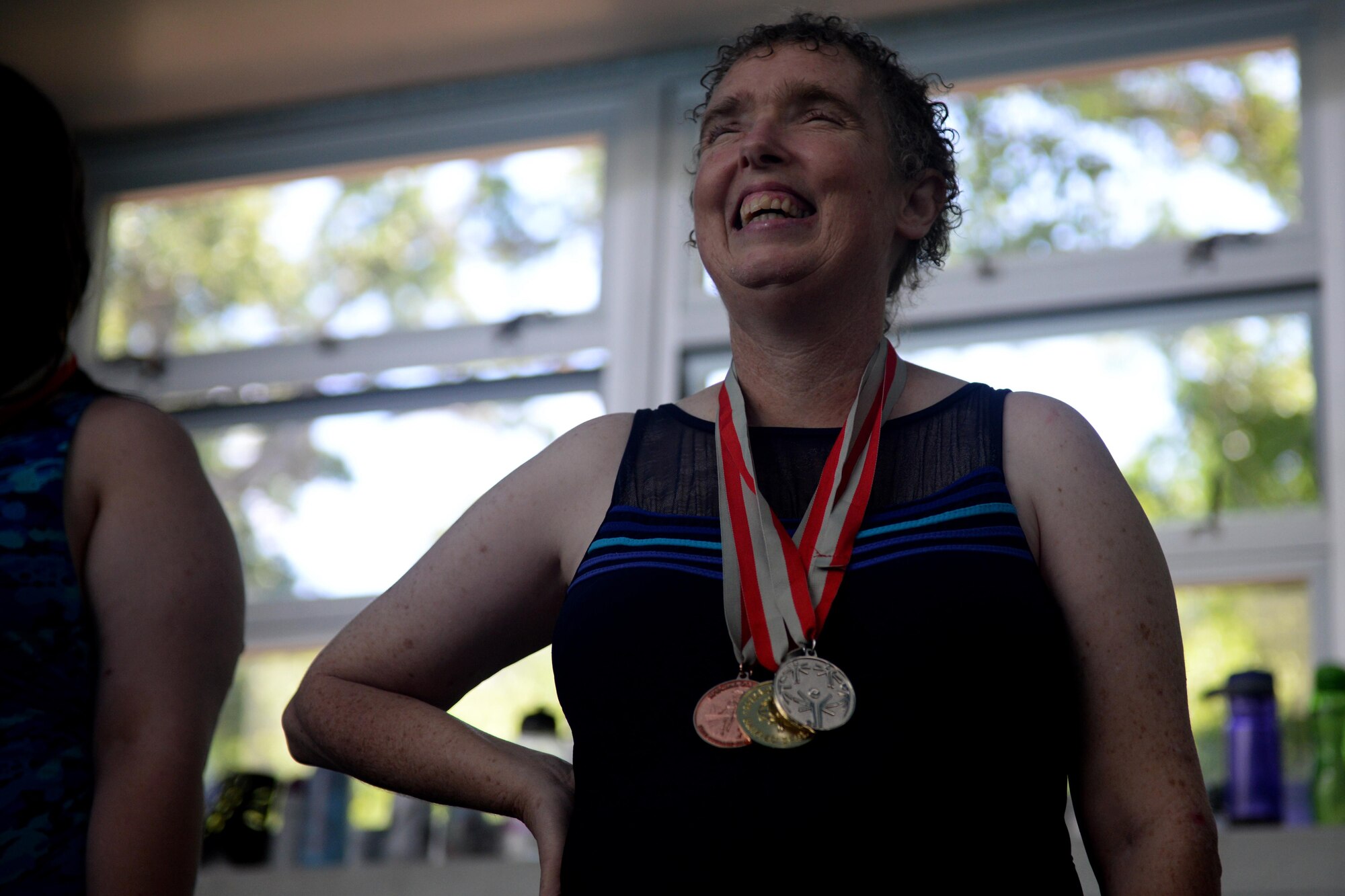 Paula Carpenter, District 5 Special Olympics Mississippi athlete, stands on the podium after receiving a medal at the Biloxi Natatorium May 21, 2016, Biloxi, Miss. Carpenter has been competing in SOMS for more than 25 years. This year she earned bronze in the 25 meter freestyle relay, silver in the 50 meter freestyle and gold in the 50 meter backstroke. (U.S. Air Force photo by Airman 1st Class Travis Beihl)