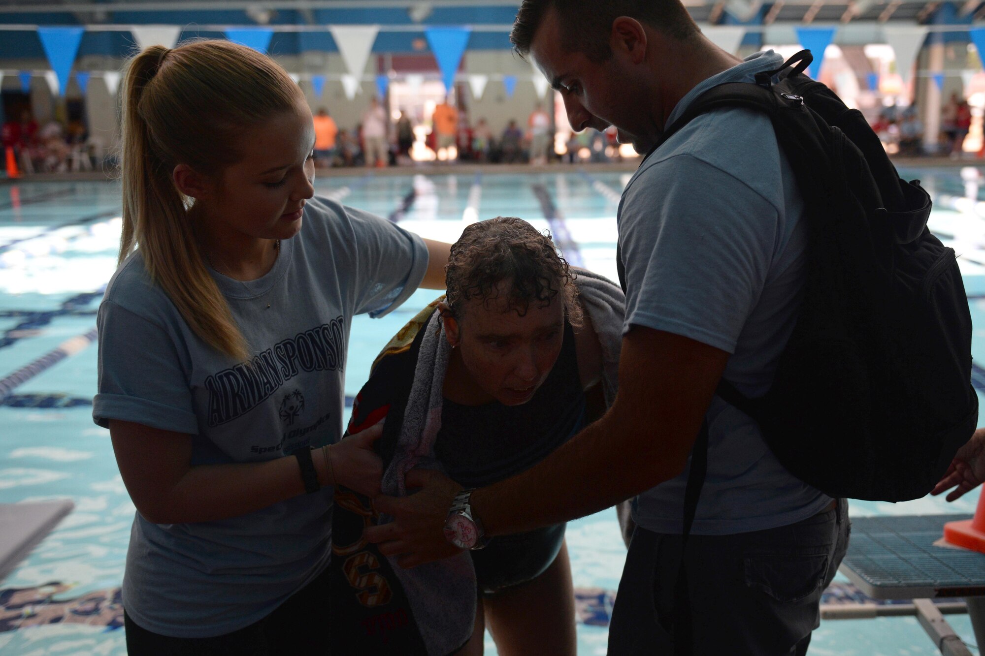 Airman Basic Ashlyn Tran and Senior Airman Hashim Mefleh, 336th Training Squadron students, aid Paula Carpenter, District 5 Special Olympics Mississippi athlete, after finishing the 50 meter backstroke at the Biloxi Natatorium May 21, 2016, Biloxi, Miss. Carpenter has competed in SOMS for more than 25 years and this year Tran and Mefleh are her Airman sponsors helping her compete in three aquatics events. (U.S. Air Force photo by Travis Beihl) 