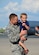 Master Sgt. Robert Mills of the 507th Maintenance Squadron at Tinker Air Force Base, Okla., holds his oldest son moments after returning from a four-month deployment from Southwest Asia June 11, 2016. Moments later, he met his two-month old son for the first time. (U.S. Air Force photo/Tech. Sgt. Lauren Gleason)
