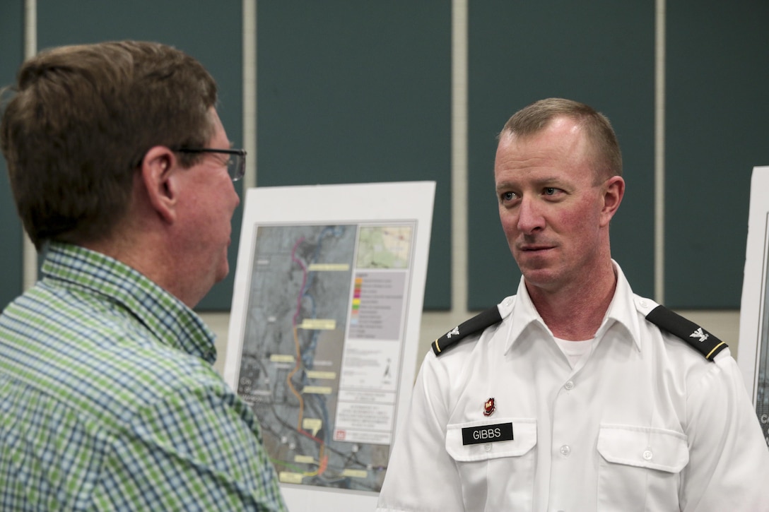 Col. Kirk Gibbs, commander of the U.S. Army Corps of Engineers Los Angeles District, speaks with Mayor Robin Boyd at the District's public meeting in Winslow, Ariz., June 9. Two meetings were held for the Draft Integrated Feasibility Report and Environmental Impact Statement on the Little Colorado River in Navajo County, Arizona. In 2008, the Federal Emergency Management Agency de-accredited the Winslow Levee.    