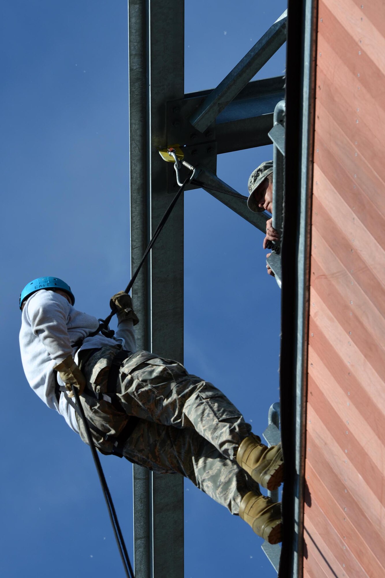Army Staff Sgt. Pedro Ortiz, a platoon sergeant with Headquarters and Headquarters Company, 1st Battalion, 501st Parachute Infantry Regiment, 4th Infantry Brigade Combat Team (Airborne), 25th Infantry Division, sounds off with words of encouragement to an Alaska School District JROTC cadet at the rappel tower on Joint Base Elmendorf-Richardson, Alaska, June 9, 2016. JBER hosted three iterations of the week-long camp where attendees participated in various camp events. (U.S. Air Force photo by Airman 1st Class Javier Alvarez) 