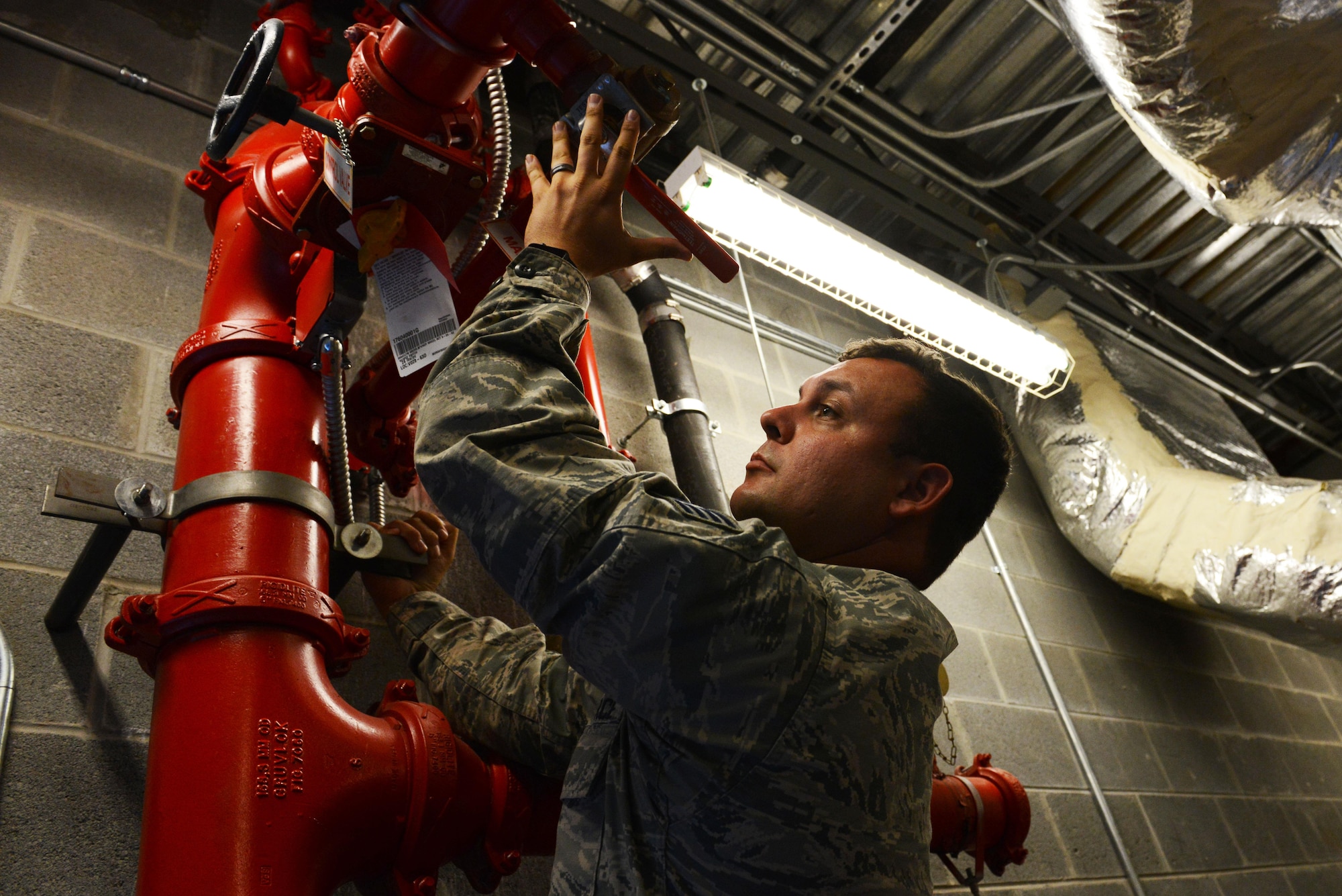 U.S. Air Force Staff Sgt. Ryan Schmutzler, 20th Civil Engineer Squadron water and fuel systems maintenance craftsman, conducts an inspection on a fire suppression system at Shaw Air Force Base, S.C., June 9, 2016. Fire suppression systems are tested annually to ensure proper function. (U.S. Air Force photo by Airman 1st Class Destinee Dougherty)