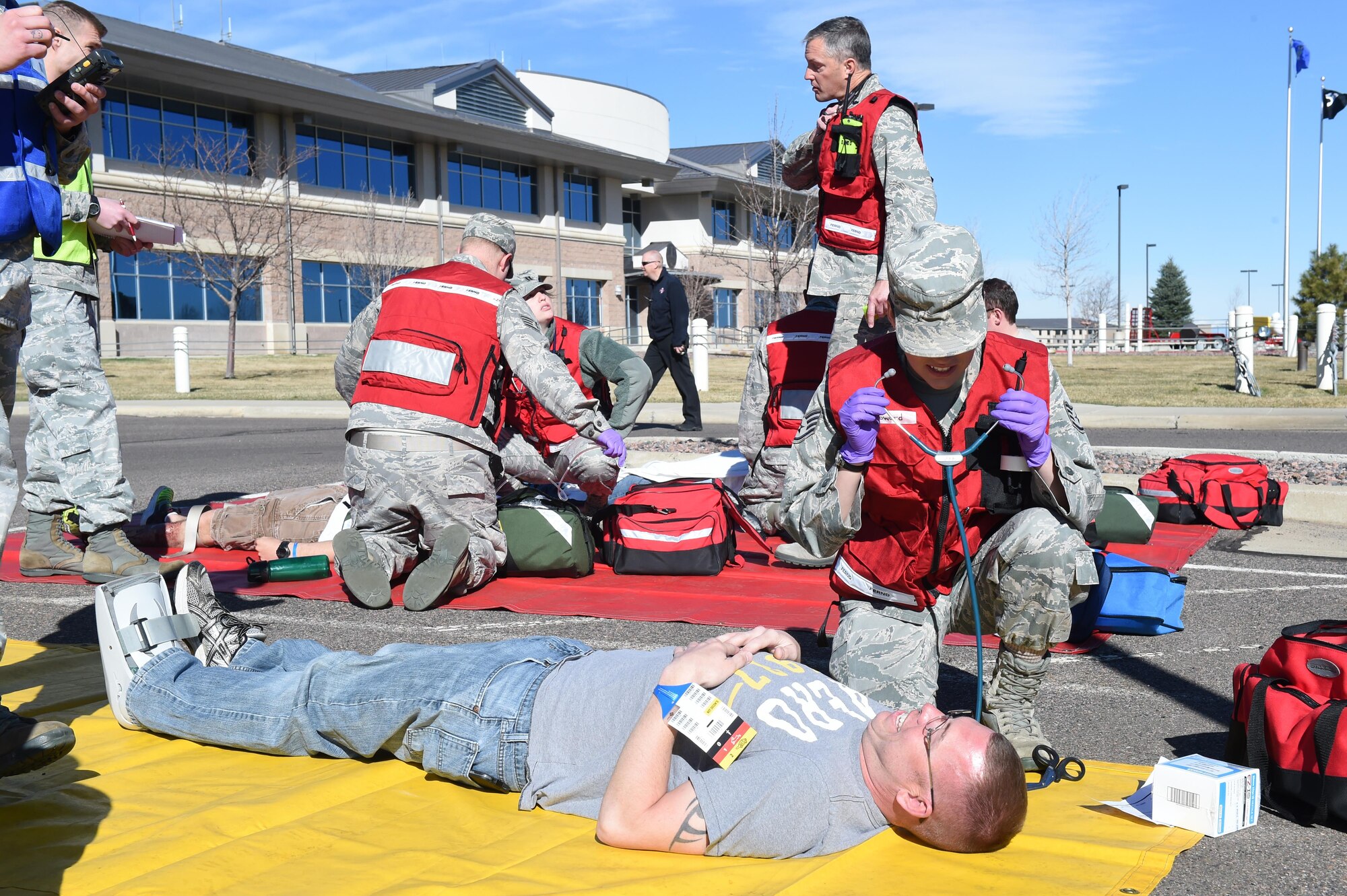 Staff Sgt. Neah Howard, 460th Medical Group medical standards NCO in charge, attends to the simulated injuries of Team Buckley members during the Panther Lighting exercise March 25, 2015, on Buckley Air Force Base, Colo. Panther Lightning is Buckley AFB’s version of the Strategic Command exercise, Global Lightning, which is an Air Force-wide exercise that focuses on all combatant commands and their missions.