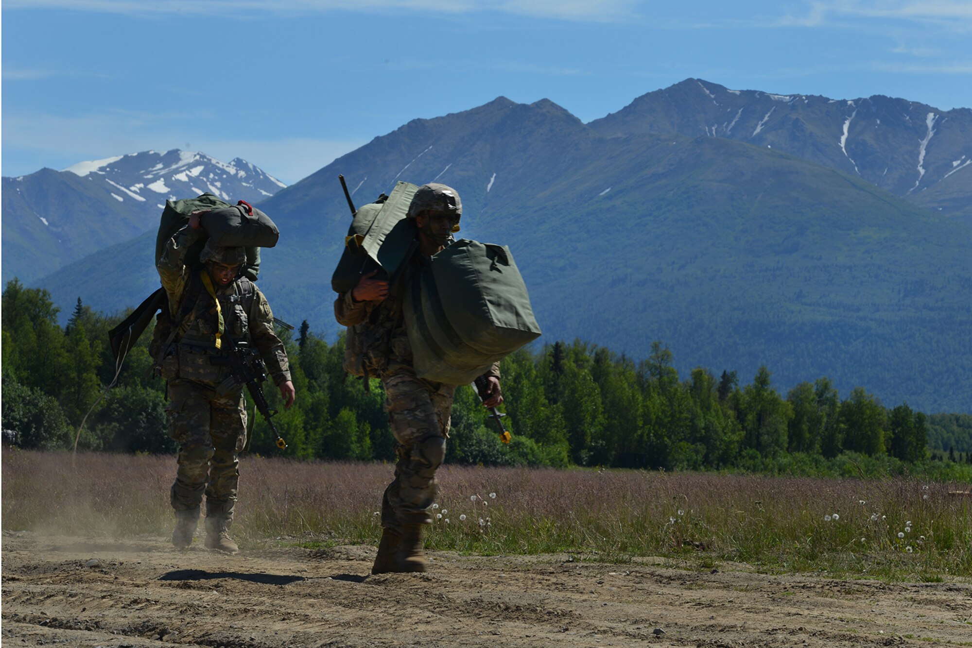 Paratroopers assigned to the 4th Infantry Brigade Combat Team (Airborne), 25th Infantry Division, U.S. Army Alaska, and the Japan Ground Self-Defense Force execute an airborne proficiency operation, and coordination for follow-on training at Joint Base Elmendorf-Richardson, Alaska, June 9, 2016, during Exercise Arctic Aurora. Arctic Aurora is a yearly bilateral training exercise involving elements of the Spartan Brigade and the JGSDF, which focuses on strengthening ties between the two by executing combined small unit airborne proficiency operations and basic small arms marksmanship. (U.S. Air Force photo by Airman 1st Class Valerie Monroy)