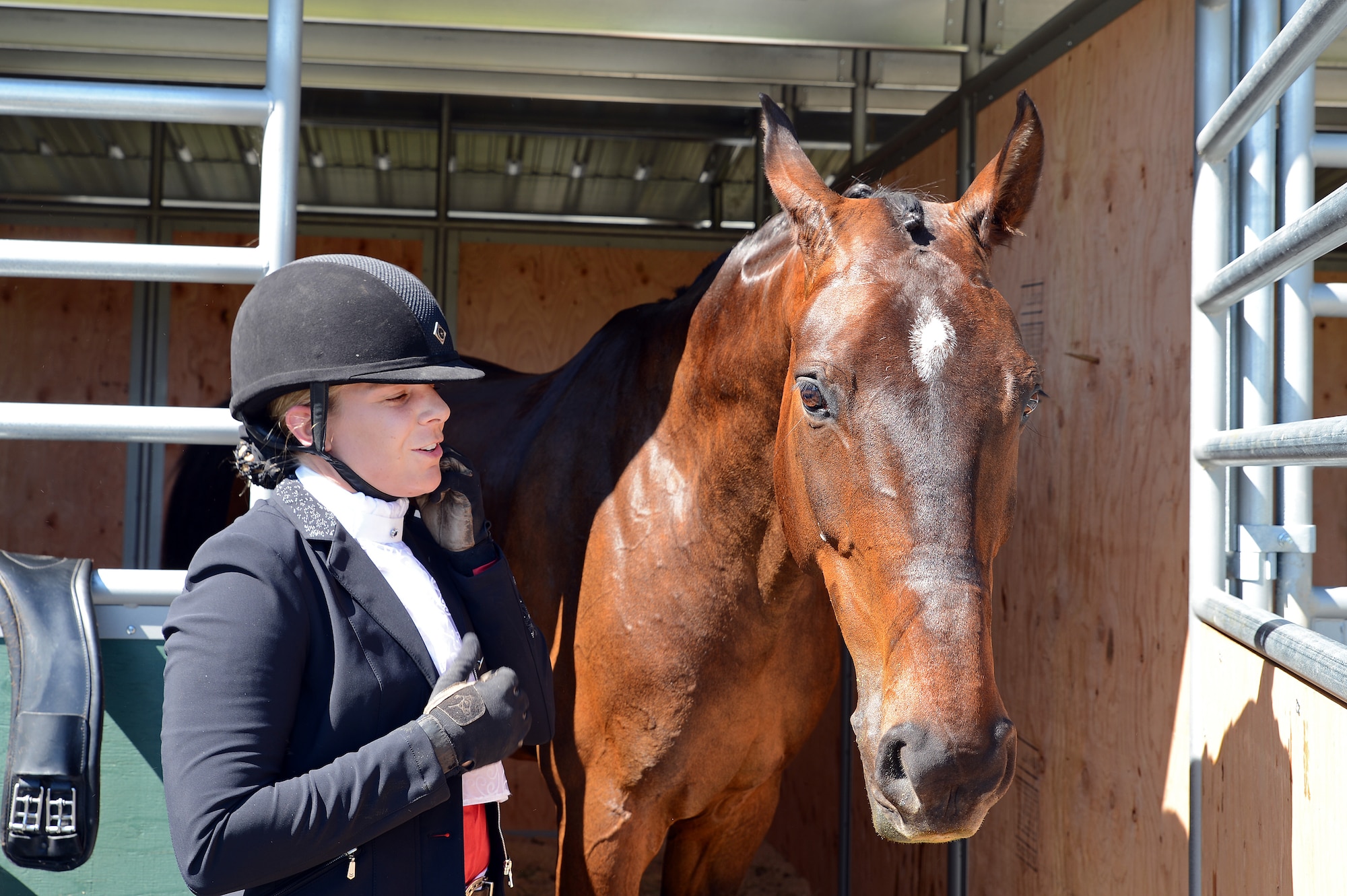 Maj. Jennifer Jones, 627th Communications Squadron director of operations, removes her riding gear from her horse, Campari, June 4, 2016, at the Summervale Premier Dressage show in Roy, Wash. Jones’ horse is her second horse to ride in equestrian competitions. (U.S. Air Force photo/ Senior Airman Jacob Jimenez) 