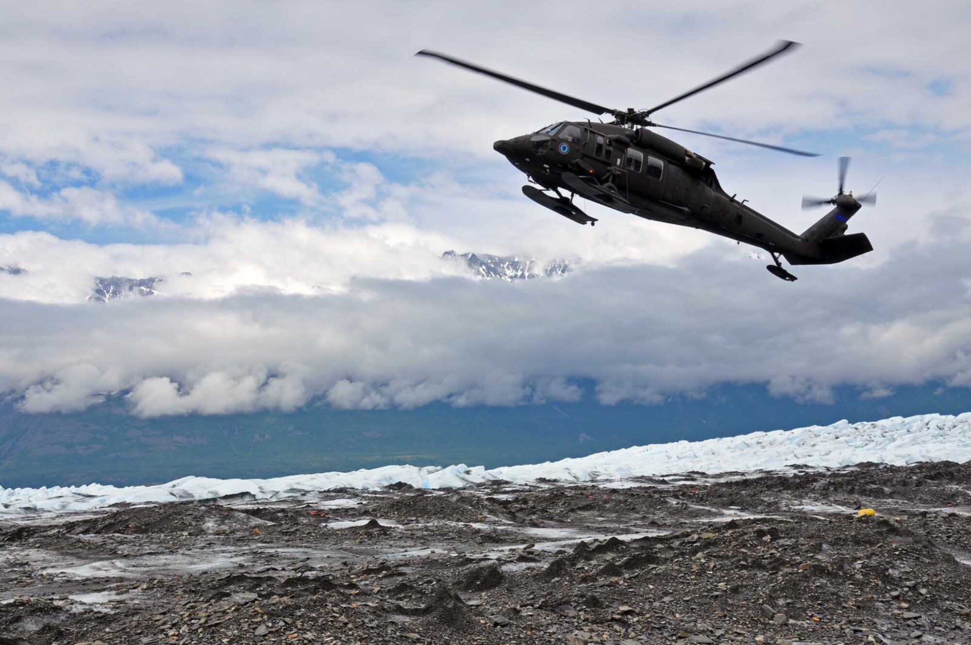 An Alaska Army National Guard UH-60 Black Hawk helicopter lands on top of Colony Glacier near Anchorage, Alaska to pick up personnel as part of Operation Colony Glacier. The operation is a mission to recover human remains and remove debris from a 1952 crash of a U.S. Air Force C-124 Globemaster II on the glacier with 52 servicemembers on board. The recovery effort has taken place every summer since 2012 by personnel from Alaskan Command, the Alaska National Guard, Air Force Mortuary Affairs Operations, U.S. Army Alaska, 673d Air Base Wing, 3d Wing and Detachment 1, 66 Training Squadron. (U.S. Air Force photo/Capt. Anastasia Wasem)