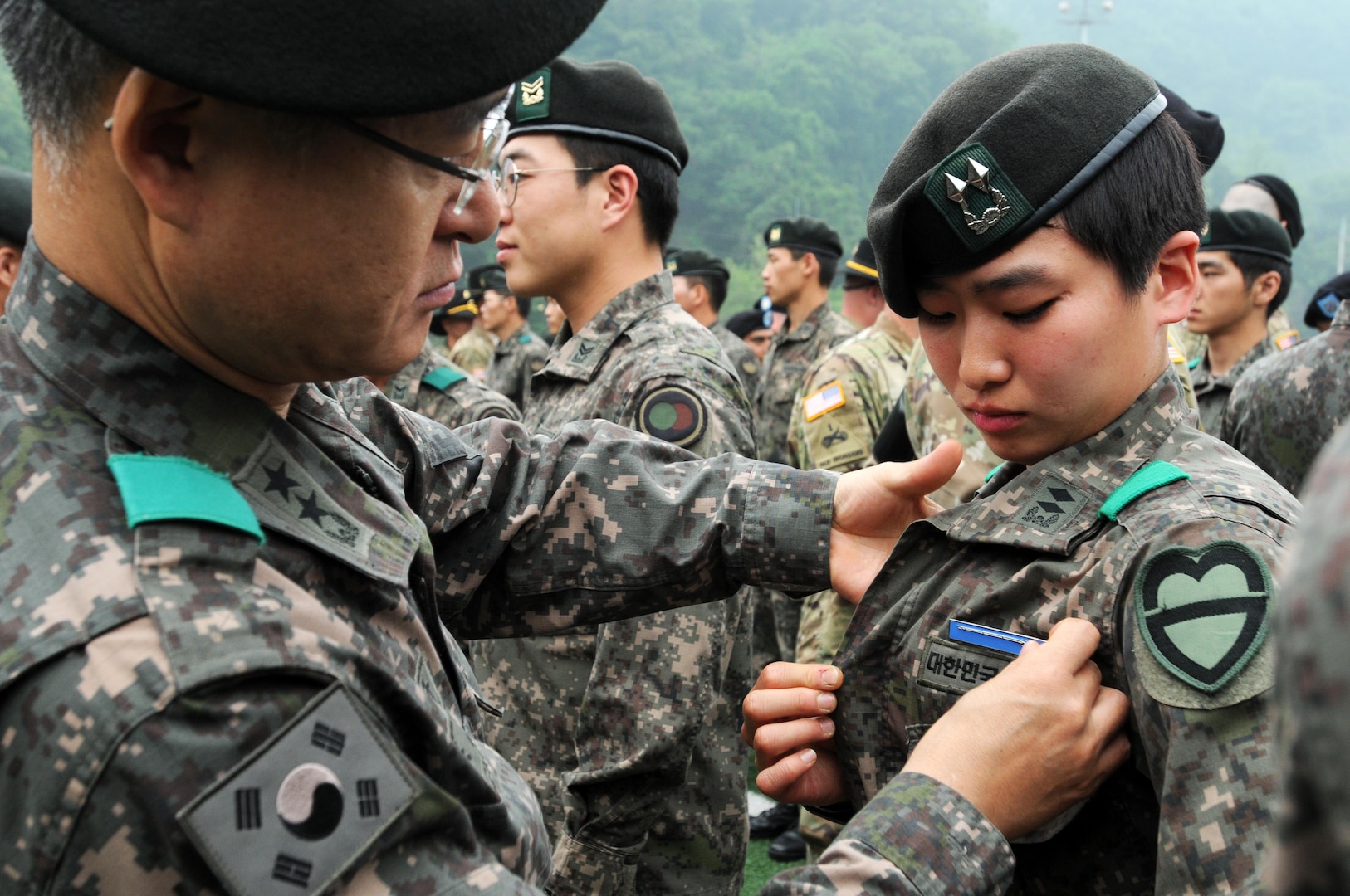 1st Lt. Jung Ji Eun - an infantryman and a Seoul native - 2nd Company, 115th Mechanized Infantry Battalion, 90th Mech. Inf. Brigade, 30th Mech. Inf. Division is pinned as the first female ROK Army officer to earn the U.S. Expert Infantry Badge, on Camp Casey, South Korea, May 26. (U.S. Army photos by Mr. Pak, Chin-U, 2nd Infantry Division/ROK-U.S. Combined Division Public Affairs Office)