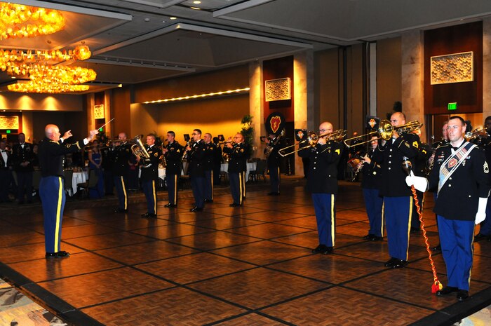 The 25th Infantry Division Tropic Lightning Band was on hand to provide inspirational melodies and music for the crowd over 700 attendees at the Army Commemoration event at the Hilton Hawaiian Village, in Honolulu, June 10. The band concluded the evening with their rendition of unit songs from each of 10 active divisions in the Army, followed by the "Army Song," an invocation by the USARPAC chaplain, Col. Michael W. Dugal, and the retiring of the colors. (U.S. Army picture by Staff Sgt. Chris McCullough, U.S. Army Pacific Public Affairs)