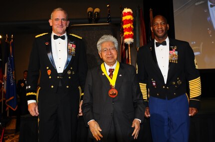 Gen. Robert B. Brown (left), U.S. Army Pacific commanding general, and Command Sgt. Maj. Bryant Lambert (right), U.S. Army Pacific command sergeant major, present the Mana O Ke Koa "Spirit of the Warrior" Award to the Honorable Daniel K. Akaka, a Hawaii U.S. Representative (1976-1990) and Senator (1990-2013). Akaka was on hand Friday evening to receive the Mana O Ke Koa "Spirit of the Warrior" Award which honors individuals who have distinguished themselves by their steadfast support of Soldiers, their Families and the Army community. The award was established by United States Army Pacific in June 2007, coinciding with the centennial celebration of Fort Shafter.  The Mana O Ke Koa award is symbolized by the Kahili, handcrafted in the traditional Hawaiian manner and made entirely of wood, bone and feathers.  Kahili were used in ancient Hawaiian times in the same way as European nobility used shields with coats of arms.  Hawaiian nobility used the Kahili to show status, lineage and family ties. Akaka shared how honored he was to have served in the Army, how he is what he is today, and how he has been able to do what he has done, thanks to his service in the U.S. Army. "I'm so grateful and appreciate the privileges that I have in helping our country's security to the United States Army," Akaka said. "I want to tell you that the Army made a huge difference in my life." (U.S. Army picture by Staff Sgt. Chris McCullough, U.S. Army Pacific Public Affairs)