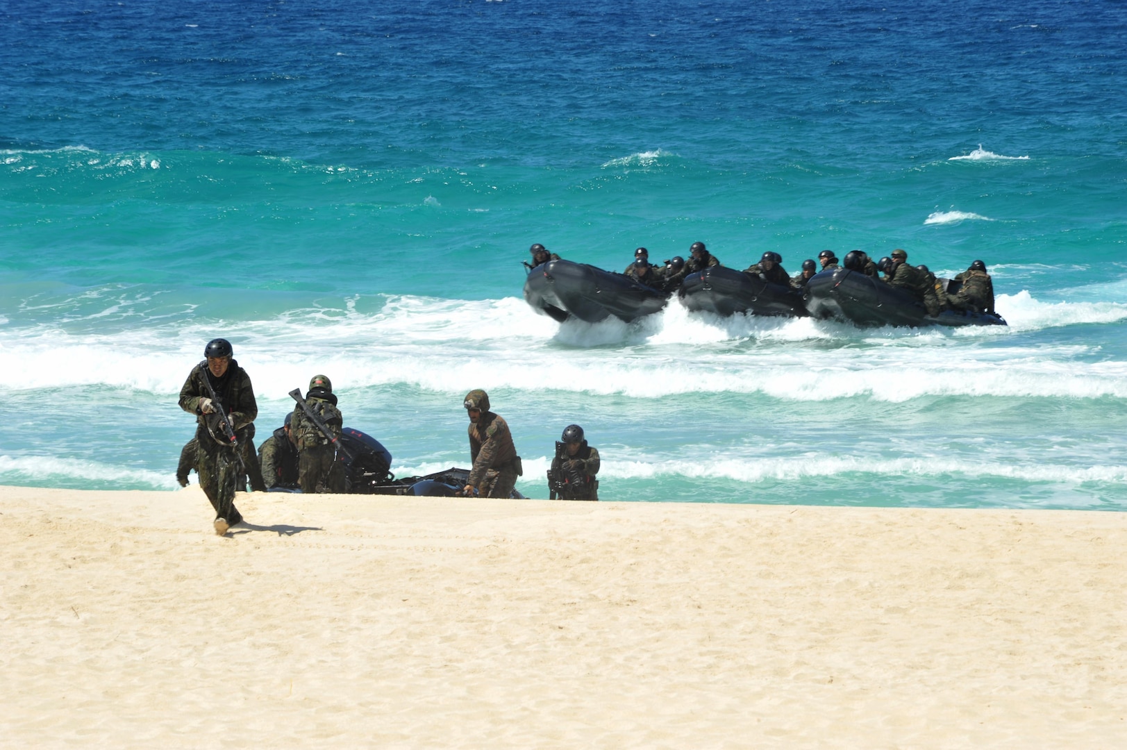 140728-N-UL721-095 MARINE CORPS BASE HAWAII (July 28, 2014) Members of Japan Ground Self-Defense Force arrive ashore performing reconnaissance during Rim of the Pacific (RIMPAC) Exercise 2014. Twenty-two nations, 49 ships, six submarines, more than 200 aircraft and 25,000 personnel are participating in RIMPAC from June 26 to Aug. 1, in and around the Hawaiian Islands and Southern California. The world's largest maritime exercise, RIMPAC provides a unique training opportunity that helps participants foster and sustain the cooperative relationships that are critical to ensuring the safety of sea lanes and security on the world's oceans. RIMPAC 2014 is the 24th exercise in the series that began in 1971. (U.S. Navy photo by Mass Communication Specialist 2nd Class Corey T. Jones/Released)