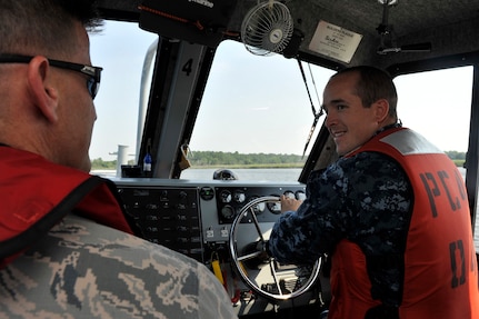 Petty Officer 1st Class Joseph Blacka, a harbor patrolman with the 628th Security Forces Squadron, speaks with Chief Master Sgt. Mark Bronson, the 628th Air Base Wing command chief, during a tour for the Honorary Commanders at Joint Base Charleston - Weapons Station, June 13, 2016. The program invites community leaders to partner with local commanders on base to grow professionally and to gain a greater understanding of the impact JB Charleston has on the local area. (U.S. Air Force photo/Tech. Sgt. Renae Pittman)