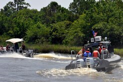 Commanders from Joint Base Charleston pair up with their honorary commanders for a tour of the Cooper River harbor patrol area at Joint Base Charleston, S.C., June 13, 2016. The program encourages local leaders to learn in-depth about the installation mission as well as increase understanding and cooperation between the civilian community and the Joint Base. (U.S. Air Force photo/Tech. Sgt. Renae Pittman)