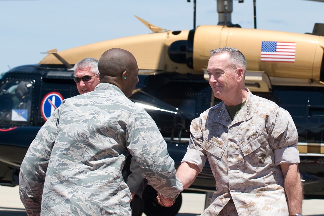 U.S. Marine Corps Gen. Joseph Dunford Jr., Chairman of the Joint Chiefs of Staff, shakes hands with U.S. Air Force 1st Lt. Nickalous Lewis, 633 Air Base Wing protocol officer, after his arrival at Joint Base Langley-Eustis, Va., June 13, 2016. Along with a tour of Air Combat Command, Dunford toured the 480th Intelligence, Surveillance and Reconnaissance Wing with U.S. Air Force Gen. Hawk Carlisle, ACC commander. (U.S. Air Force photo by Airman 1st Class Kaylee Dubois)