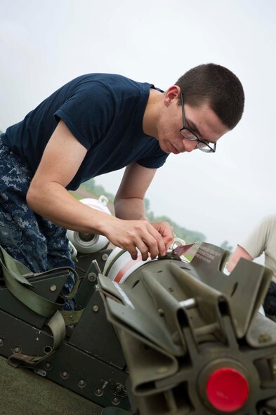 U.S. Seaman Clarence Burns, Navy Munitions Command Unit Charleston mineman, assembles a MK-62 Quick Strike inert mine at Royal Air Force Fairford, United Kingdom, June 8, 2016. The mines were built for a BALTOPS 16 exercise mission where B-52H Stratofortresses tested their ability to precisely drop munitions into a target zone. (U.S. Air Force photo/Senior Airman Sahara L. Fales)