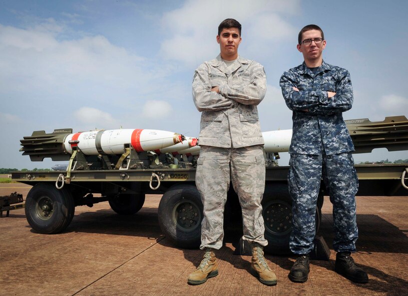U.S. Senior Airman Kody Regelbrugge, 5th Expeditionary Munitions Squadron conventional maintenance crew chief, and Seaman Clarence Burns, Navy Munitions Command Unit Charleston mineman, pose in front of a trailer of MK-62 Quick Strike inert mines at Royal Air Force Fairford, United Kingdom, June 8, 2016. This was both members’ first time participating in exercise BALTOPS 16 and a joint-service environment.(U.S. Air Force photo/Senior Airman Sahara L. Fales)