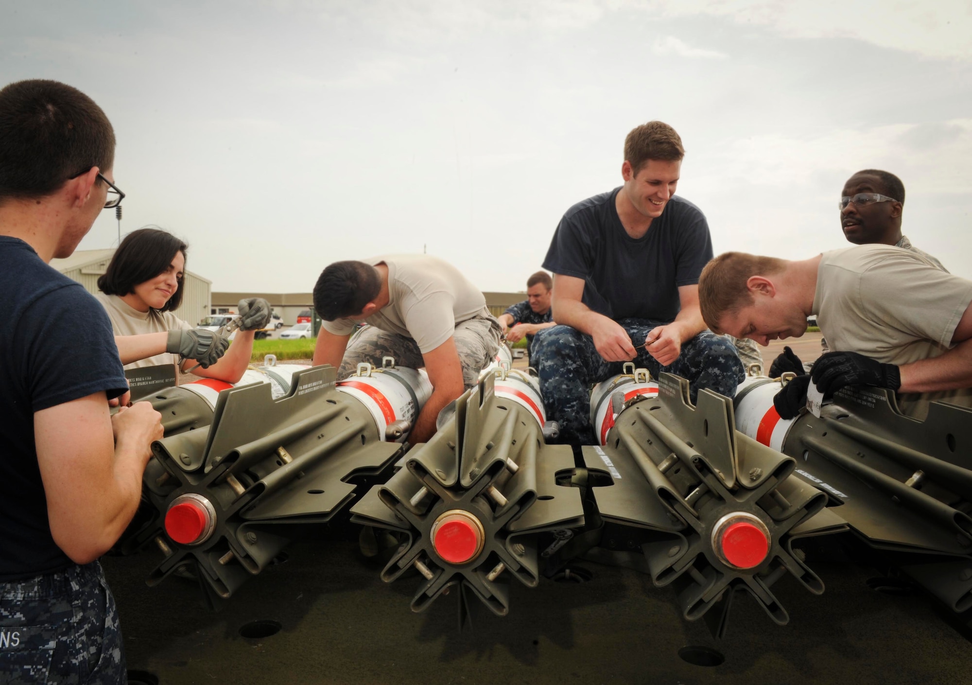 Minot Air Force Base 5th Munitions Squadron Airmen and U.S. Navy Munitions Command Unit Charleston minemen assemble a trailer of MK-62 Quick Strike inert mines at Royal Air Force Fairford, United Kingdom, June 8, 2016. The mines were built in support of exercise BALTOPS 16, which provides an opportunity for personnel from different services and nations to engage in realistic maritime training to build experience and teamwork and strengthen interoperability (U.S. Air Force photo/Senior Airman Sahara L. Fales)