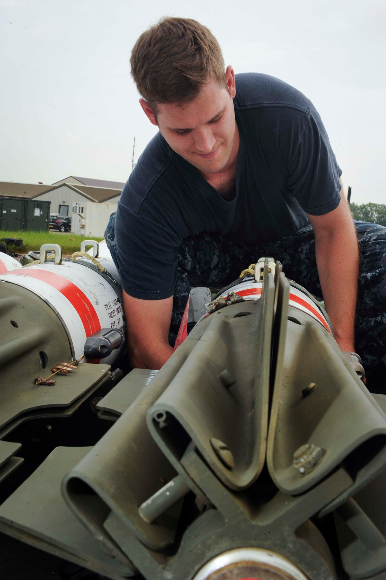 U.S. Petty Officer 2nd Class Ray Charles Newman, Navy Munitions Command Unit Charleston mineman, assembles a MK-62 Quick Strike inert mine at Royal Air Force Fairford, United Kingdom, June 8, 2016. The mines were built for a BALTOPS 16 exercise mission where B-52H Stratofortresses tested their ability to precisely drop munitions into a target zone. (U.S. Air Force photo/Senior Airman Sahara L. Fales)