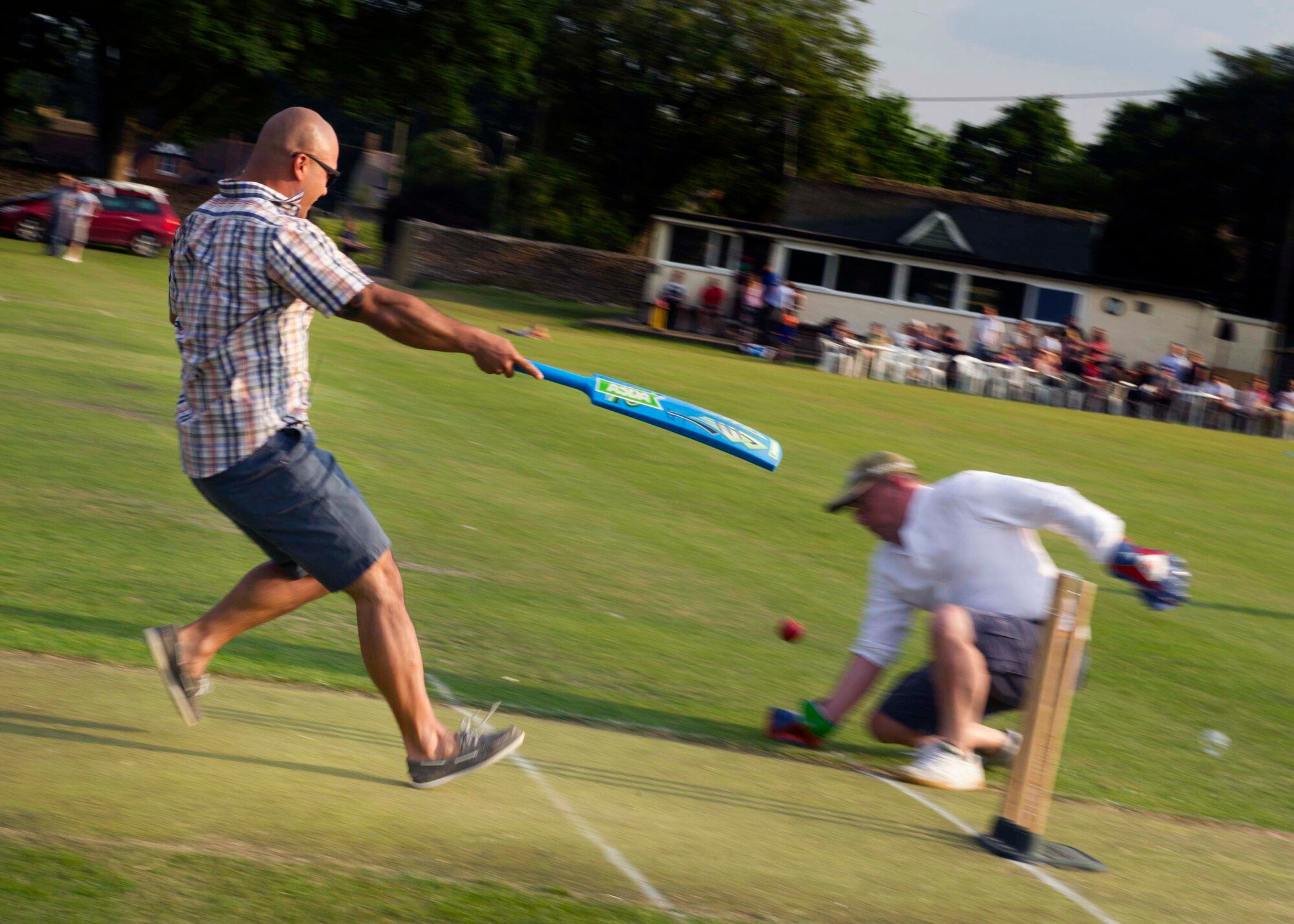 Tech. Sgt. Christopher Aflleje, 5th Expeditionary Aircraft Maintenance Squadron weapons expediter, races to ground his bat, scoring a run for his team at the Fairford Cricket Club, June 8, 2016. The RAF Fairford British-American Committee hosts a cricket game annually to bring together members from the base and the local area to maintain community relations. (U.S. Air Force photo/Senior Airman Sahara L. Fales)
