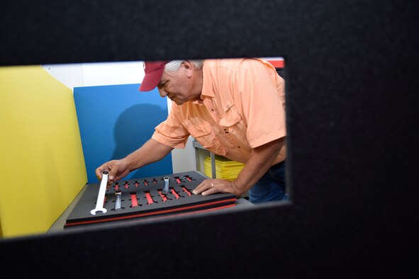 David Marsey, 76th Maintenance Support Group tool attendant, performs a fit-check of wrenches with the custom, laser-cut foam cut-outs he has made while building a tool box for a customer within the Oklahoma City Air Logistics Complex, June 3, 2016, Tinker Air Force Base, Okla. Marsey is framed by a large opening cut in black foam waiting to receive high contrast red foam before being placed in the drawer. (U.S. Air Force photo/Greg L. Davis)