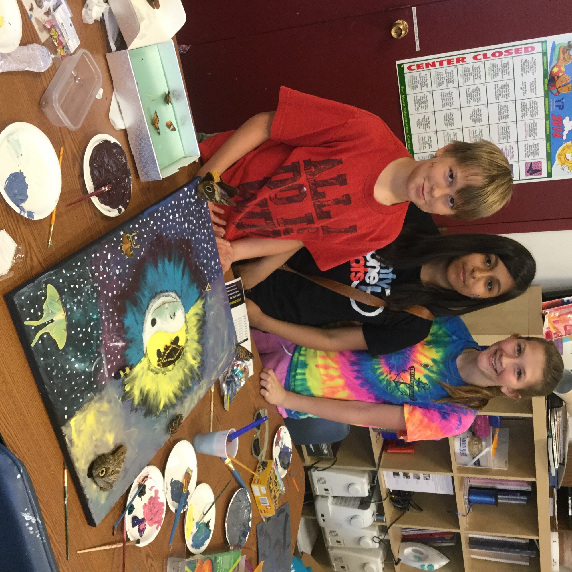 Victor Vise, 11 (left) Ella Morales, 12, and Taylor Murray, 12, made an acrylic painting using several insect specimens. (U.S. Air Force photo/Joel McKeever, Prairies Youth Center, youth programs assistant)