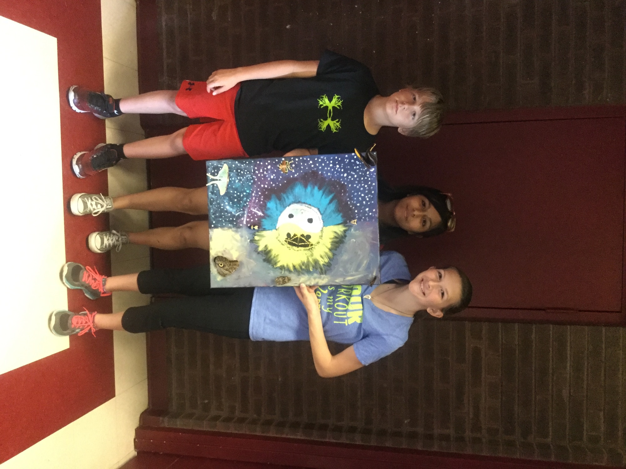 Victor Vise, 11 (left), Ella Morales, 12, and Taylor Murray, 12, made an acrylic painting using several insect specimens. (U.S. Air Force photo/Joel McKeever, Prairies Youth Center, youth programs assistant.)