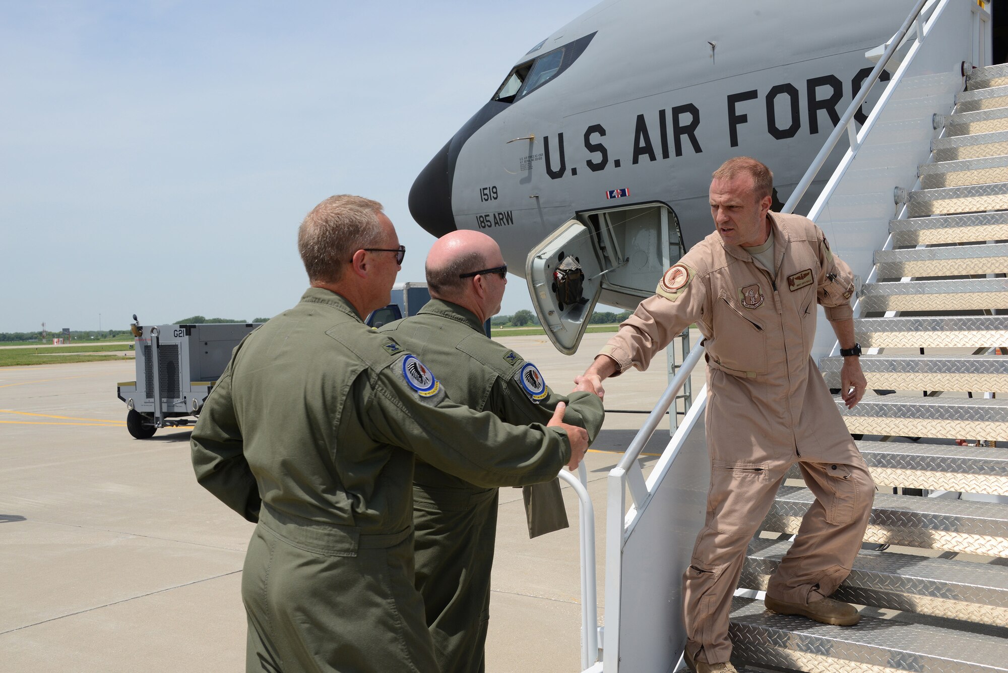 Col Lawrence Christensen, 185th Air Refueling Wing Commander, Iowa Air National Guard and Colonel Jim Walker 185th Operations Group commander, greet Senior Master Sgt. Chuck Heald at the bottom of the air stair of a KC-135R Stratotanker, in Sioux City, Iowa on June 11, 2016 after returning from Al Udeid Air Base. 185th ARW unit members and aircraft were temporarily assigned to the 340th Expeditionary Air Refueling Squadron at Al Udeid since February, where they were providing midair refueling support for U.S. and partner nation aircraft in direct support of Operation Inherent Resolve.
(U.S. Air Guard Photo by: Master Sgt. Vincent De Groot/released) 