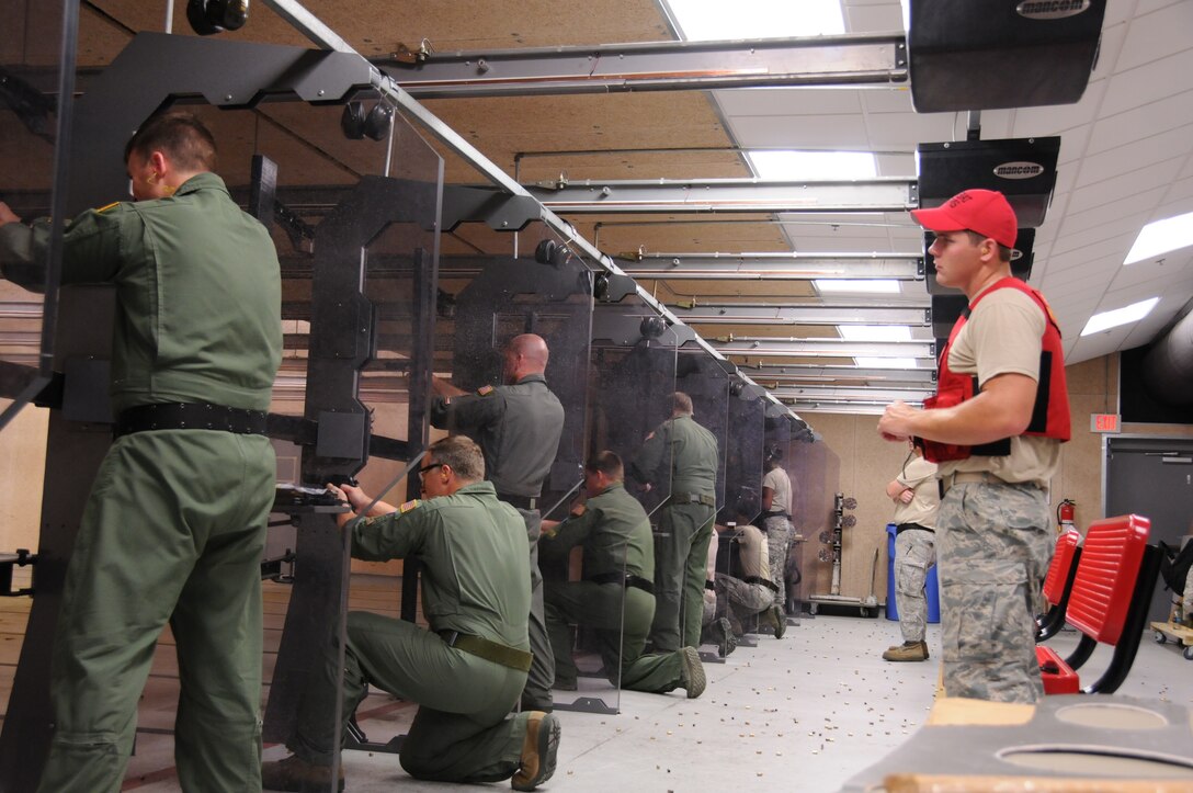 186th Air Refueling Wing Citizen Airmen fire their M9 pistols during weapons qualification at the Keesler Air Force Base indoor firing range in Biloxi, Miss., June 7, 2016. 186th Security Forces personnel instructed the group on how to shoot, operate, maintain and clear their firearms to complete their qualification. (U. S. Air National Guard Photo by Tech. Sgt. Richard L. Smith/Released)