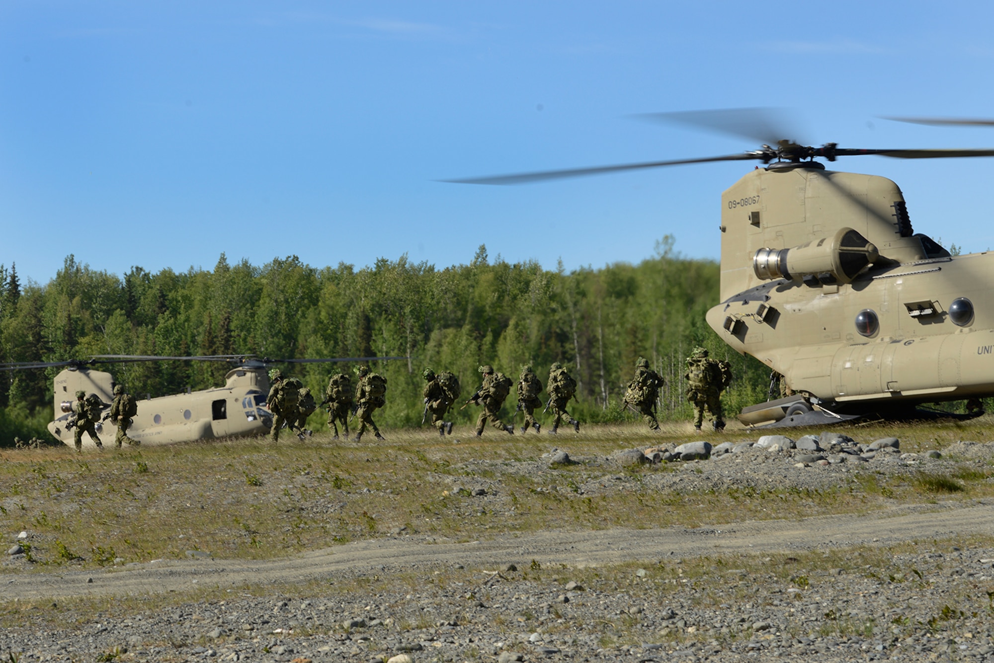 Paratroopers assigned to the 4th Infantry Brigade Combat Team (Airborne), 25th Infantry Division, U.S. Army Alaska, and the Japan Ground Self-Defense Force execute an airborne proficiency operation, and coordination for follow-on training at Joint Base Elmendorf-Richardson, Alaska, June 9, 2016, during Exercise Arctic Aurora. Arctic Aurora is a yearly bilateral training exercise involving elements of the Spartan Brigade and the JGSDF, which focuses on strengthening ties between the two by executing combined small unit airborne proficiency operations and basic small arms marksmanship. (U.S. Air Force photo by Airman 1st Class Valerie Monroy)