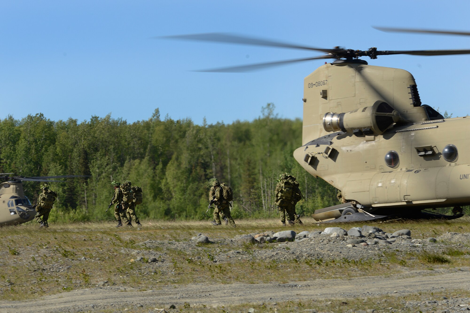 Paratroopers assigned to the 4th Infantry Brigade Combat Team (Airborne), 25th Infantry Division, U.S. Army Alaska, and the Japan Ground Self-Defense Force execute an airborne proficiency operation, and coordination for follow-on training at Joint Base Elmendorf-Richardson, Alaska, June 9, 2016, during Exercise Arctic Aurora. Arctic Aurora is a yearly bilateral training exercise involving elements of the Spartan Brigade and the JGSDF, which focuses on strengthening ties between the two by executing combined small unit airborne proficiency operations and basic small arms marksmanship. (U.S. Air Force photo by Airman 1st Class Valerie Monroy)
