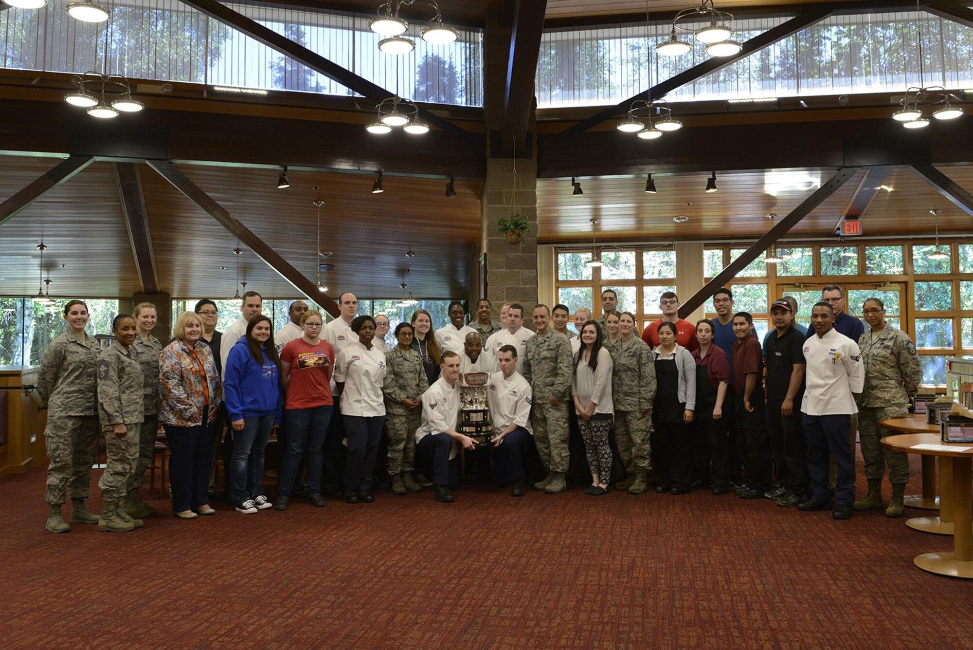 Air Force Lt. Col Christopher Busque, 673d Force Support Squadron commander, presents the 2016 John L. Hennessy Award to the Iditarod Dining Facility personnel at Joint Base Elmendorf-Richardson, Alaska, June 8, 2016. The award is not only a high-level Air Force award but benefits all those who receive it if they decide to pursue a culinary career outside of the military. (U.S. Air Force photo by Airman 1st Class Valerie Monroy)