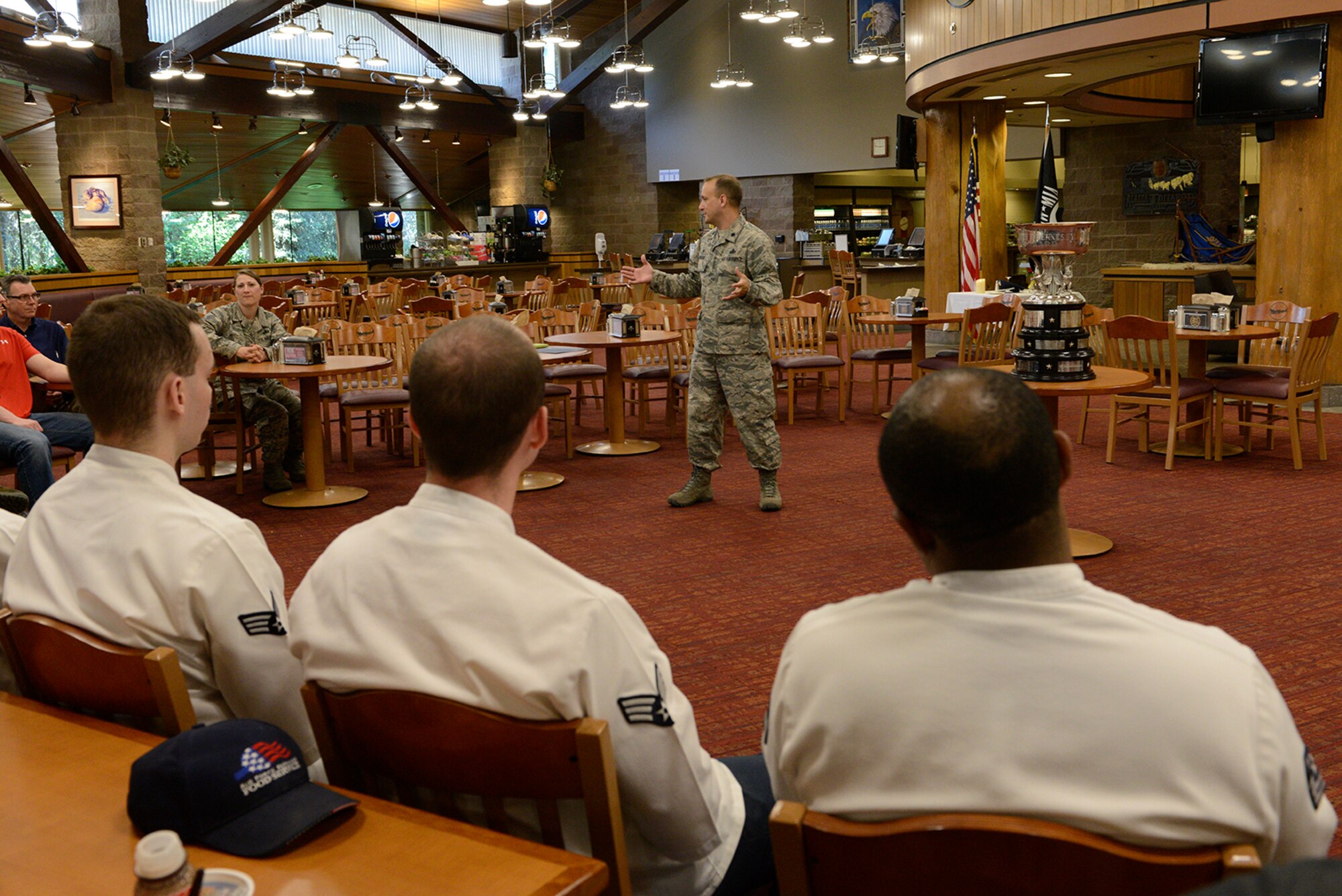 Air Force Lt. Col Christopher Busque, 673d Force Support Squadron commander, speaks to Iditarod Dining Facility personnel about their accomplishment in winning the 2016 John L. Hennessy Award at Joint Base Elmendorf-Richardson, Alaska, June 8, 2016. According to Hennessy Travelers Association, the award winners must display excellence in management effectiveness, force-readiness support, food quality, employee and customer relations, resource conservation and training, and safety awareness.(U.S. Air Force photo by Airman 1st Class Valerie Monroy)