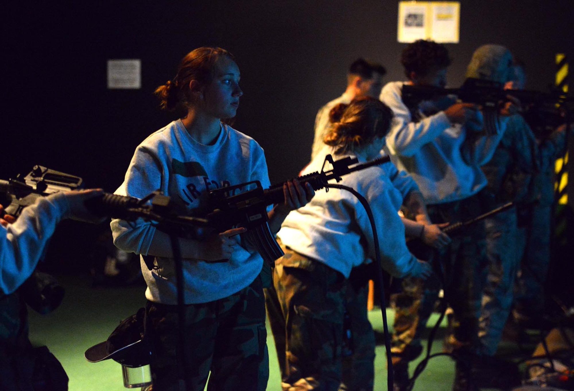 Alaska School District JROTC cadets prepare for a virtual-reality turkey hunt with M-4s at the Engagement Skills Trainer 2000 on Joint Base Elmendorf-Richardson, Alaska, June 8, 2016. Soldiers on JBER use the EST 2000 for small arms training, squad drills, practice zeroing, qualification, and shoot/don’t-shoot scenarios. (U.S. Air Force photo by Airman 1st Class Javier Alvarez)
