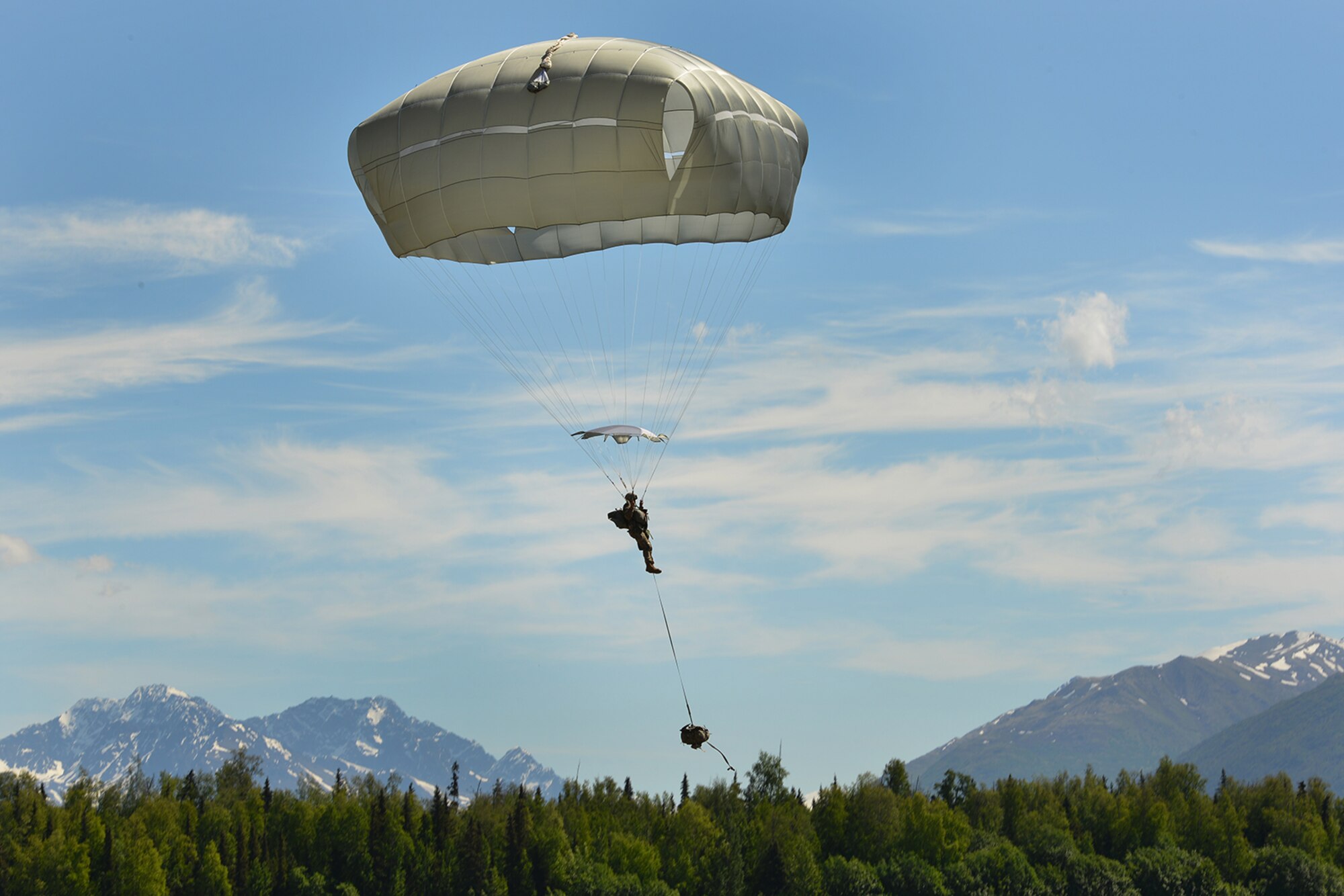 Paratroopers assigned to the 4th Infantry Brigade Combat Team (Airborne), 25th Infantry Division, U.S. Army Alaska, and the Japan Ground Self-Defense Force execute an airborne proficiency operation, and coordination for follow-on training at Joint Base Elmendorf-Richardson, Alaska, June 9, 2016, during Exercise Arctic Aurora. Arctic Aurora is a yearly bilateral training exercise involving elements of the Spartan Brigade and the JGSDF, which focuses on strengthening ties between the two by executing combined small unit airborne proficiency operations and basic small arms marksmanship. (U.S. Air Force photo by Airman 1st Class Valerie Monroy)