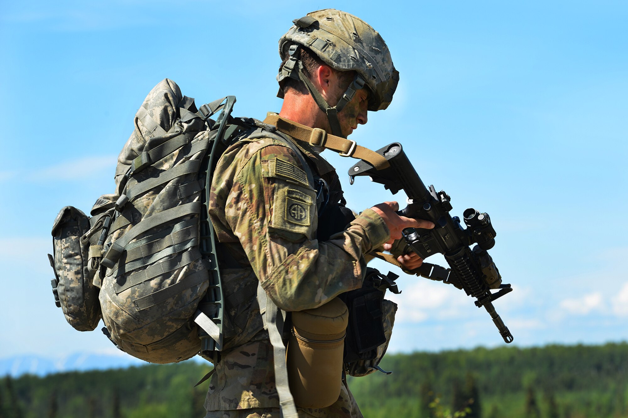 Sgt. Andrew Oexmann, assigned to the 4th Infantry Brigade Combat Team (Airborne), 25th Infantry Division, U.S. Army Alaska, recovers his parachute while executing an airborne proficiency operation, and coordination for follow-on training at Joint Base Elmendorf-Richardson, Alaska, June 9, 2016, during Exercise Arctic Aurora. Arctic Aurora is a yearly bilateral training exercise involving elements of the Spartan Brigade and the JGSDF, which focuses on strengthening ties between the two by executing combined small unit airborne proficiency operations and basic small arms marksmanship. (U.S. Air Force photo by Airman 1st Class Valerie Monroy)