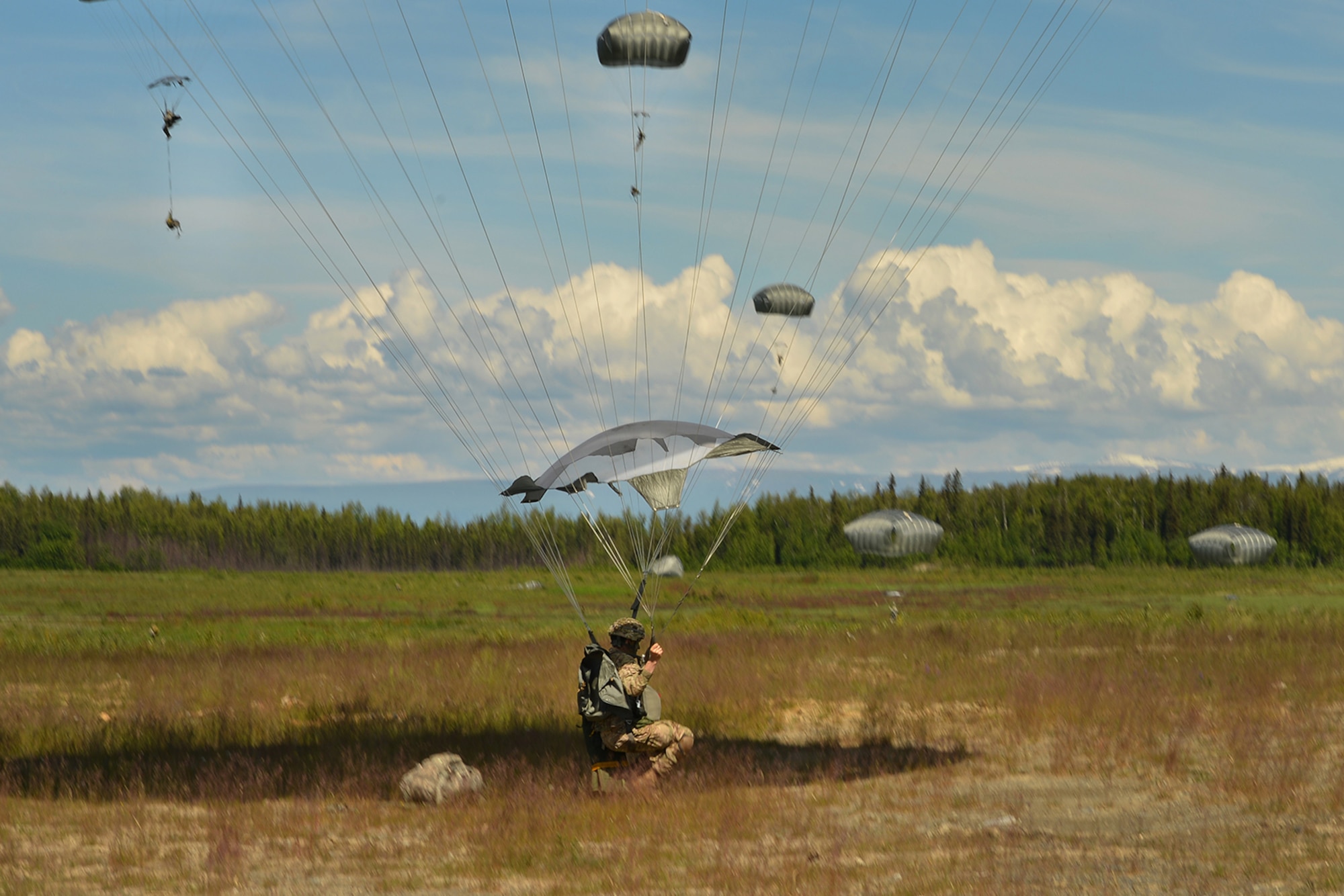 Paratroopers assigned to the 4th Infantry Brigade Combat Team (Airborne), 25th Infantry Division, U.S. Army Alaska, and the Japan Ground Self-Defense Force execute an airborne proficiency operation, and coordination for follow-on training at Joint Base Elmendorf-Richardson, Alaska, June 9, 2016, during Exercise Arctic Aurora. Arctic Aurora is a yearly bilateral training exercise involving elements of the Spartan Brigade and the JGSDF, which focuses on strengthening ties between the two by executing combined small unit airborne proficiency operations and basic small arms marksmanship. (U.S. Air Force photo by Airman 1st Class Valerie Monroy)