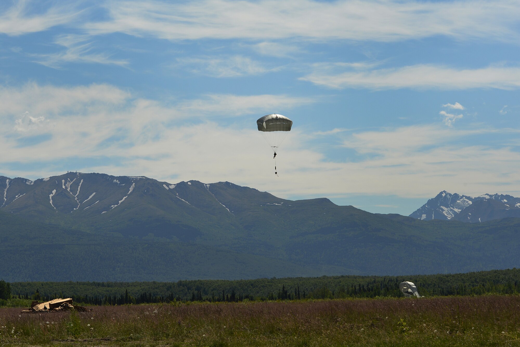 Paratroopers assigned to the 4th Infantry Brigade Combat Team (Airborne), 25th Infantry Division, U.S. Army Alaska, and the Japan Ground Self-Defense Force execute an airborne proficiency operation, and coordination for follow-on training at Joint Base Elmendorf-Richardson, Alaska, June 9, 2016, during Exercise Arctic Aurora. Arctic Aurora is a yearly bilateral training exercise involving elements of the Spartan Brigade and the JGSDF, which focuses on strengthening ties between the two by executing combined small unit airborne proficiency operations and basic small arms marksmanship. (U.S. Air Force photo by Airman 1st Class Valerie Monroy)
