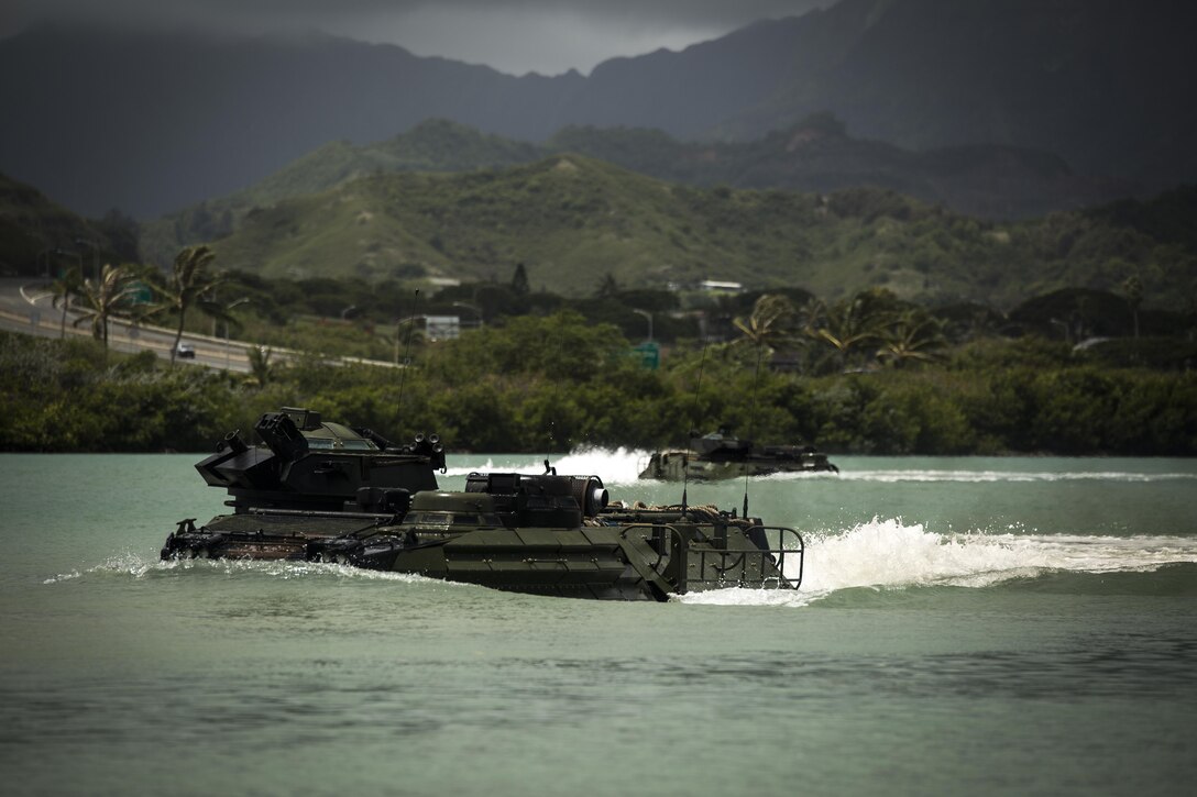 Amphibious Assault Vehicles with Combat Assault Company, 3rd Marine Regiment, prepare to drive ashore near the Pacific War Memorial on Marine Corps Base Hawaii, June 13, 2016. The CAC Marines practiced towing drills in Kaneohe Bay to gain a good understanding of what to do in the event an AAV breaks down or gets stuck.