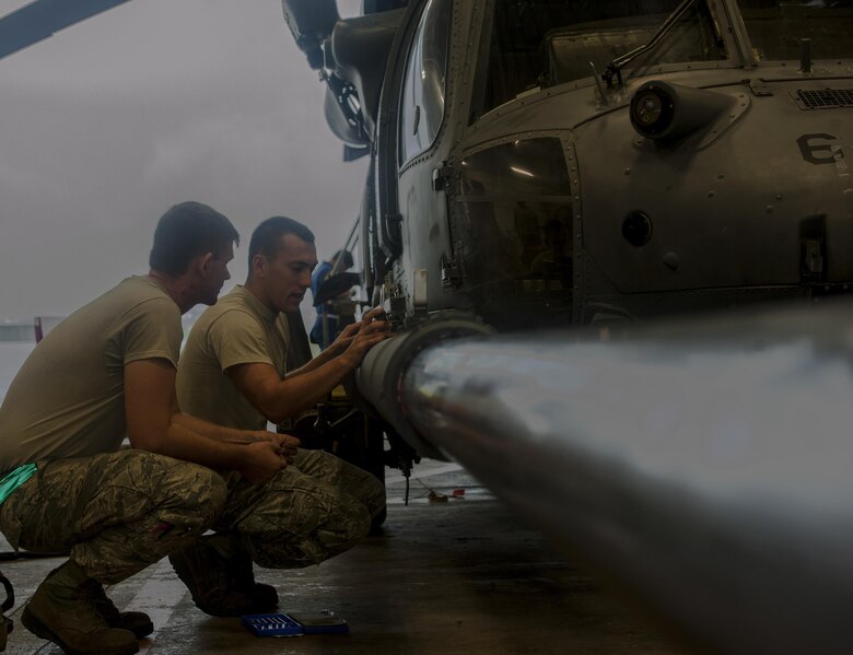 U.S. Air Force Staff Sgt. Cody Reigard and Airman 1st Class Zachary Zander, 33rd Helicopter Maintenance Unit crew chiefs, install a mount for a scale June 14, 2016, at Kadena Air Base, Japan. The scale showed the strength of the HH-60G Pave Hawk’s fuel probe when pressure was applied to it. (U.S. Air Force photo by Airman 1st Class Lynette M. Rolen) 