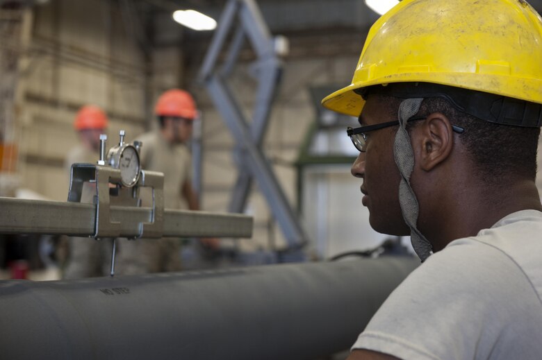 U.S. Air Force Airman 1st Class Joshua Clement, 33rd Helicopter Maintenance Unit crew chief, monitors measurements on a scale June 14, 2016, at Kadena Air Base, Japan. The fuel probe on the HH-60G Pave Hawk was inspected for durability when different amounts of pressure were applied to it. (U.S. Air Force photo by Airman 1st Class Lynette M. Rolen)